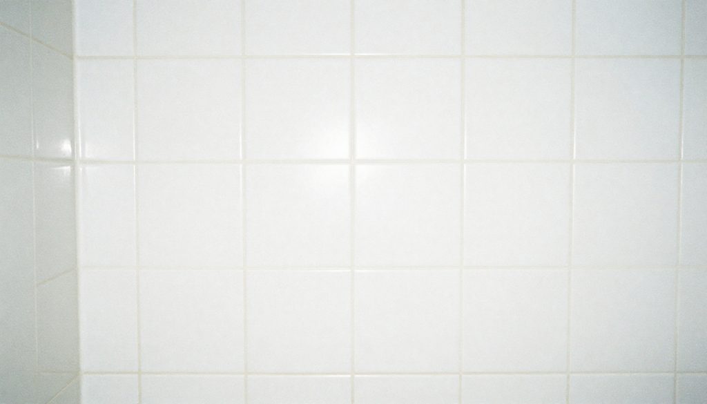 Clean white bathroom tiles with grout