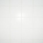 Clean white bathroom tiles with grout